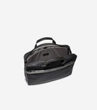 Black fabric slim briefcase with black leather trim and top handles. Main compartment is open, revealing a gray patterned lin