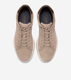 Tan suede lace-up sneakers with white soles and dark brown leather collar trim. Cole Haan logo on side, blue insoles.