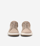 A pair of taupe suede low-top sneakers with matching laces, white midsoles, and light brown outsoles. A subtle CH logo is on