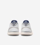 Pair of light grey quick-on oxfords with dark blue tongues, 'CH' logo, laser-cut details, and cream soles.