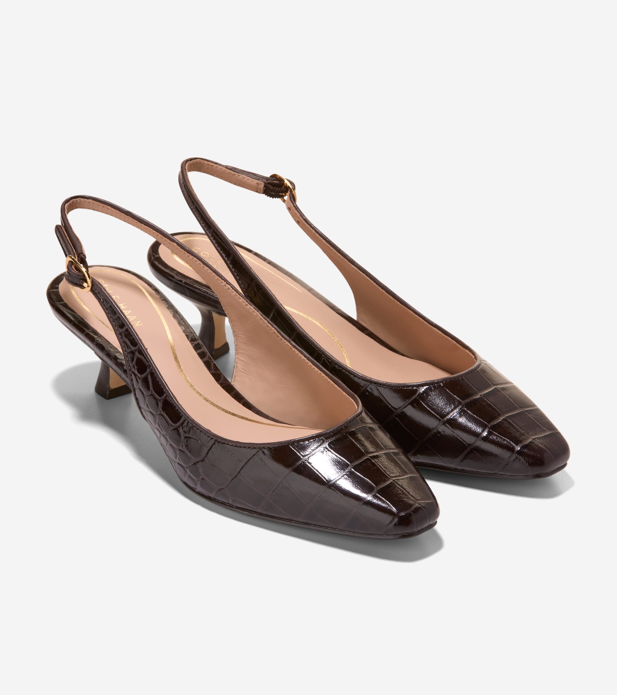 Dark brown patent leather slingback pumps with crocodile embossing, soft square toes, flared kitten heels, and gold-toned buc