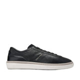 Black pebbled leather low-top sneakers with white platform sole and grey trim, featuring black laces and Cole Haan branding.