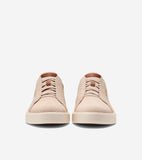 Pair of beige knit slip-on sneakers with elasticized laces and a brown tab on the tongue, set on light beige soles.