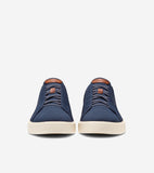 Pair of navy blue knit slip-on sneakers with elastic laces, brown leather-like tongue patches, and thick cream soles.