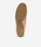 Tan suede sneaker with a light brown rubber sole featuring a diamond grid pattern, wavy edges, and "COLE HAAN GRAND OS" text.