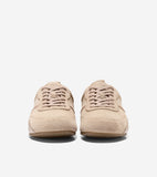 Pair of light tan suede sneakers with matching laces, a thin darker tan stripe on the sides, and light brown soles.