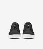 Pair of black knit slip-on sneakers with white soles and black elastic laces. Small black tag on tongue.