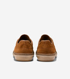 Back view of two brown suede sneakers with tan soles. Each heel features an embossed circular logo and 'COLE HAAN' on the sol