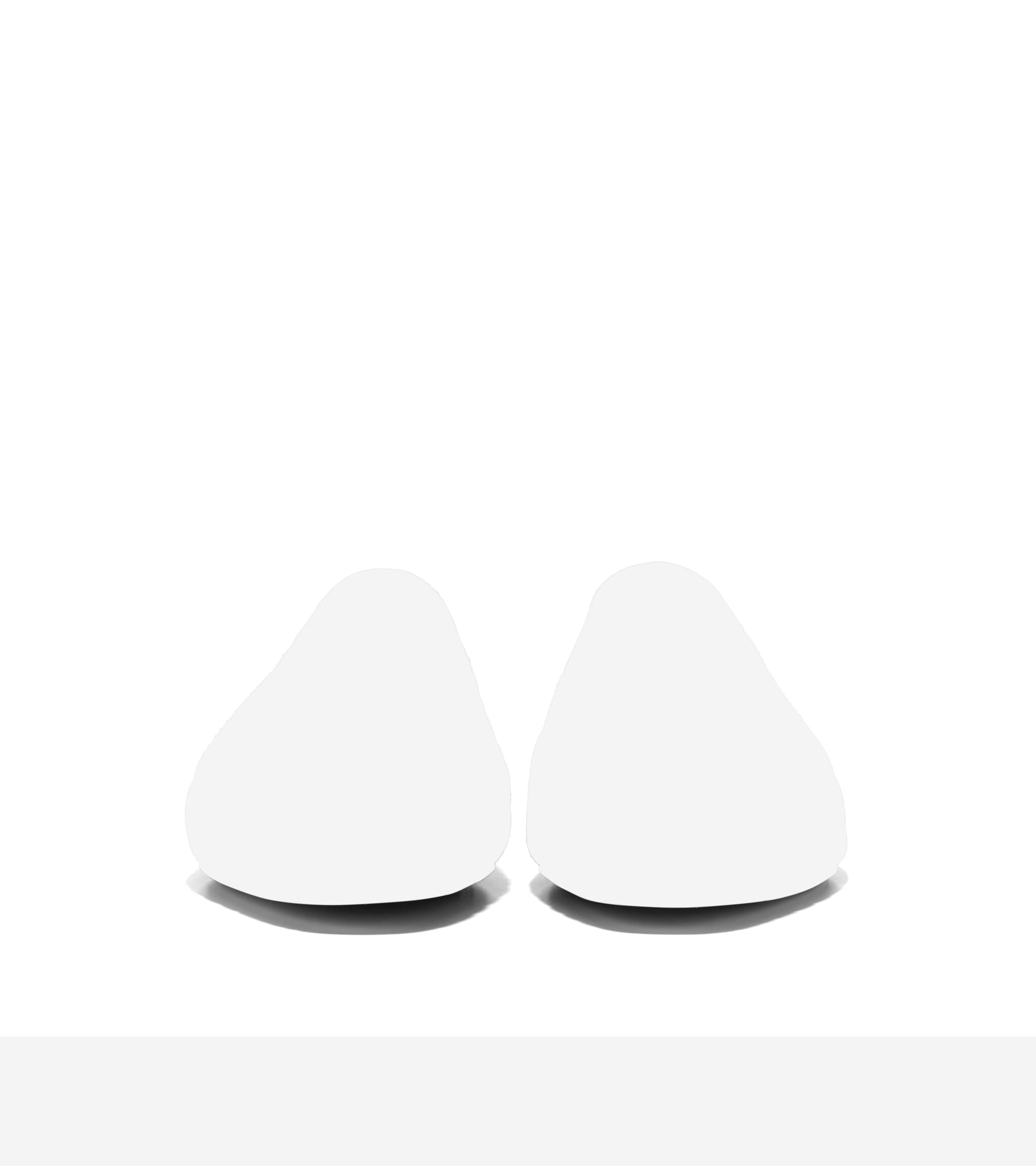 Two blurry white rounded shapes, likely the toes of ballet flats, with no discernible details.
