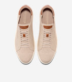 Pair of beige knit slip-on sneakers with brown trim, decorative laces, and white soles.