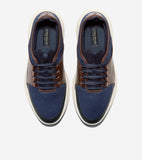 Pair of navy blue mesh and brown perforated sneaker oxfords with dark blue laces and thick, textured off-white soles.