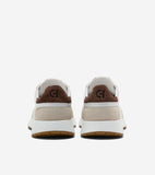 Back view of two slip-on sneakers. White leather, beige suede side panels, brown suede heel tabs with 'CH' logo. White midsol