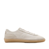 Light beige Cole Haan GrandPrø Packwell low-top sneaker with a pebbled upper, tonal laces, and a translucent gum rubber sole.