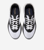 Pair of white mesh running sneakers with black synthetic overlays, white laces, and chunky white soles. Gold-toned brand name