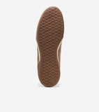 Brown sneaker sole with diamond-patterned tread and a white stripe along the edge. "COLE HAAN GRAND 360" is embossed on the h