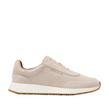Light beige Cole Haan GrandPrø Luxe Mile slip-on trainers with a suede upper, white midsole, and gum rubber outsole.