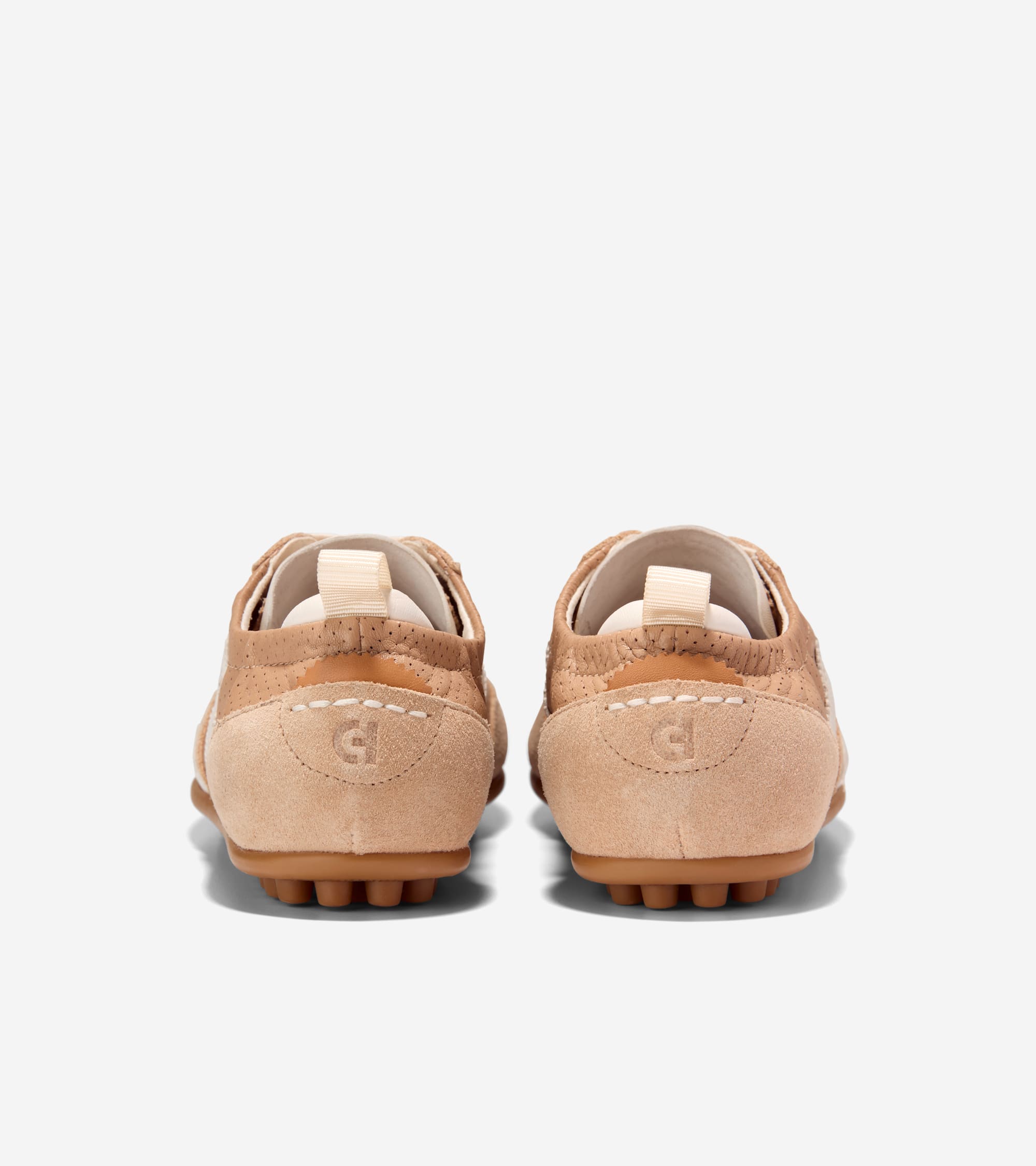 Pair of light tan sneakers, back view. Suede heels with debossed CH logo, perforated upper, white stitching, and brown nubbed