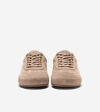 Pair of tan suede low-top sneakers with lighter stitching, flat tan laces, and a circular CH logo on the tongue.