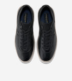 Black textured leather low-top sneakers with black laces, white midsoles, and navy insoles featuring gold-toned branding.