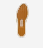 Sneaker sole with a tan wavy textured pattern and an off-white border. 'COLE HAAN' is embossed on the arch.