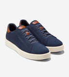 Navy blue Stitchlite™ slip-on sneakers with off-white soles, brown leather heel collars, and brown leather lace loops.