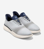 Light gray athletic oxfords with navy blue collar, tongue, and lace loops. Perforated uppers, light gray laces, and cream tex