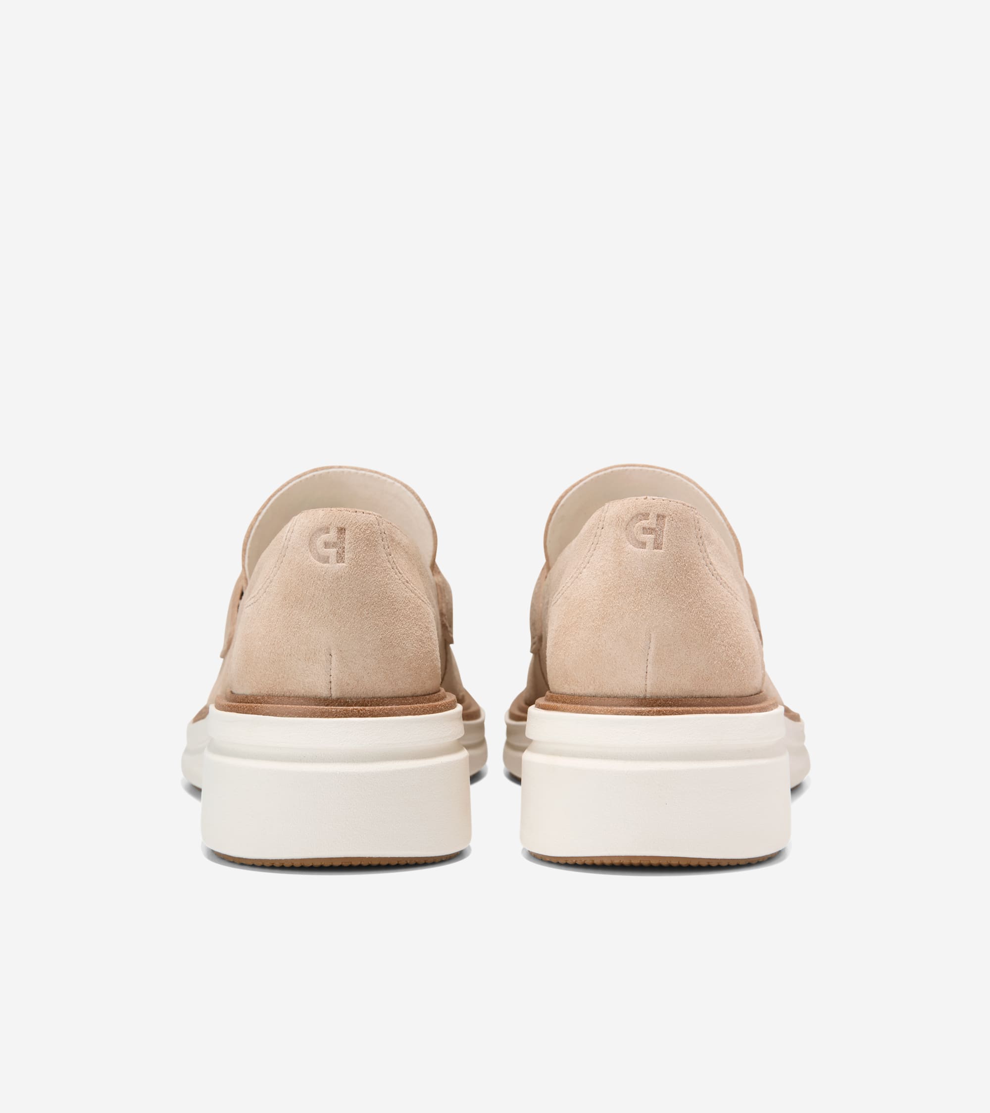 Light tan suede platform loafers with thick white soles and a brown trim. An embossed 'CH' logo is on the back of each heel.