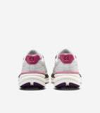White sneakers with magenta heel collars, white 'CH' logo heel tabs, white midsoles with magenta stripe, and purple outsoles.