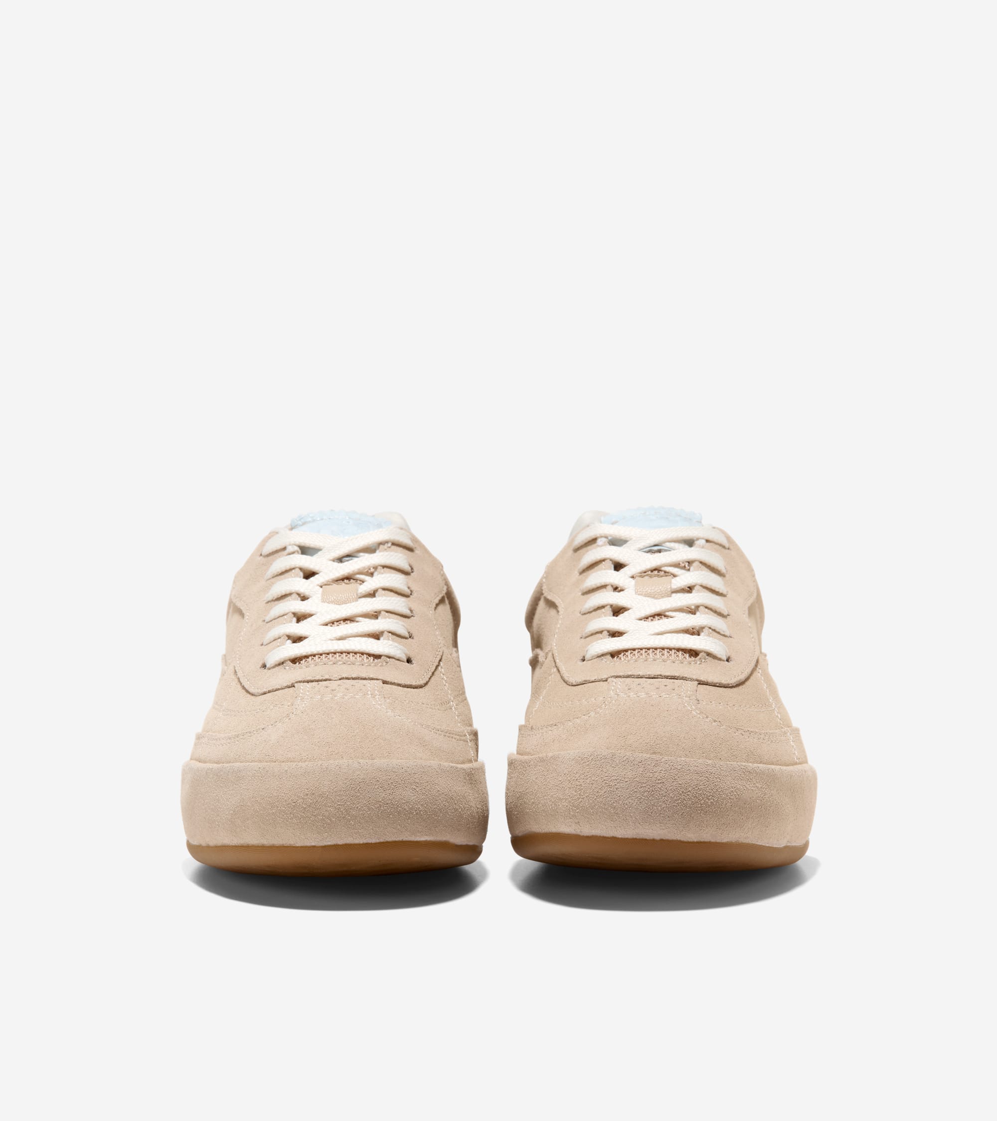 Pair of light beige suede sneakers with cream laces, thick beige platform soles, and light blue interior lining.