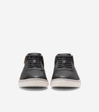 Pair of dark grey leather low-top sneakers with black laces, brown collar trim, and white soles with a subtle textured patter