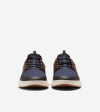 Pair of navy blue knit sneakers with brown leather-like overlays, dark laces, cream midsoles, and brown outsoles.