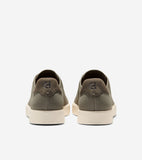 Pair of olive green knit slip-on sneakers with dark olive heel tabs featuring an embossed 'CH' logo, and cream soles.