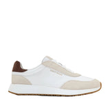 White and beige panelled slip-on sneakers with brown suede heel tab, gum outsole, and gold-toned Cole Haan logo.