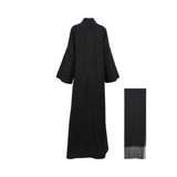 Rear view of the Bazzah Couture abaya showing the seamless drape of the premium black fabric and embroidered detailing on the back of the sleeves.