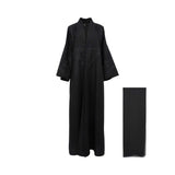 Front view of a black Bazzah Couture abaya with intricate floral embroidery on the chest and wide sleeves, shown with a matching black headscarf.