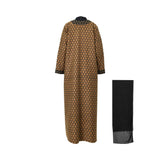 The back of the Bazzah Couture gold and black embroidered abaya showing the continuous damask pattern and high collar.