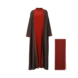 Full view of Bazzah Couture 3-piece set featuring a rust-red inner dress under a dark floral print open abaya with a matching red headscarf.