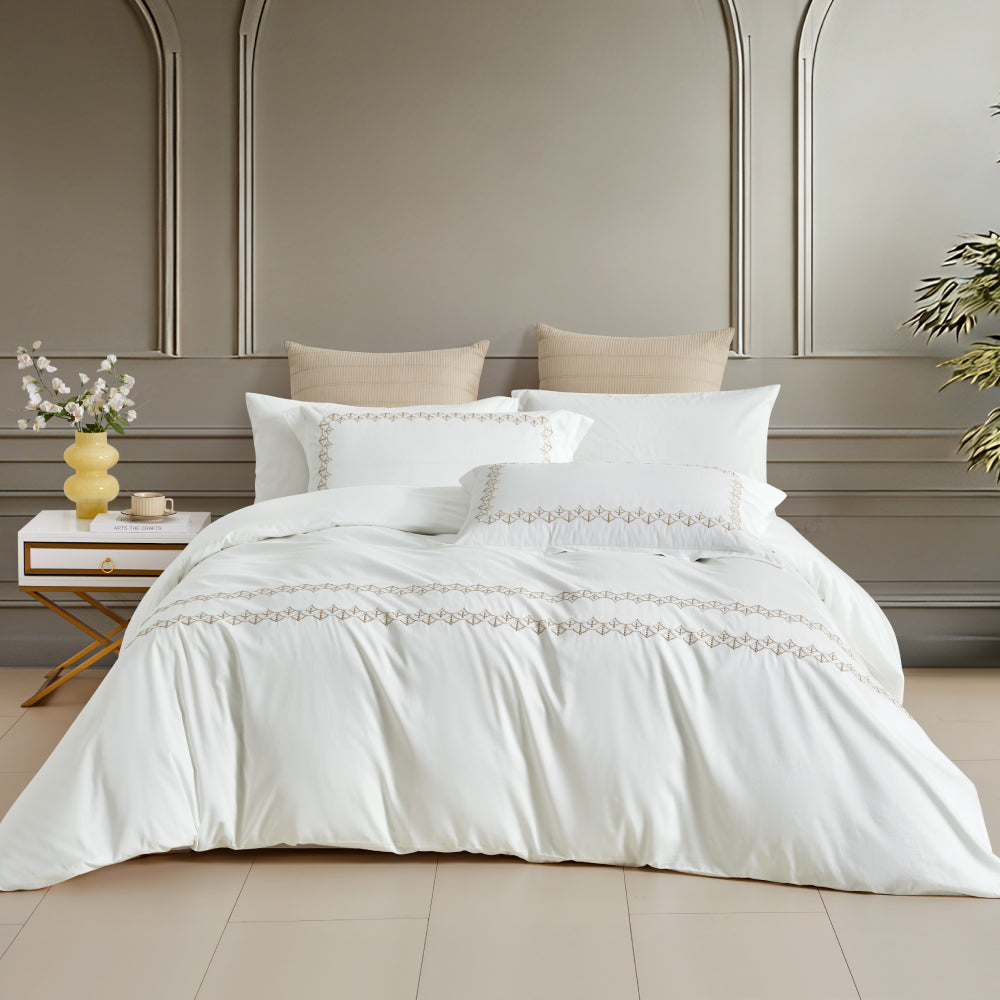 A timeless white bedding set featuring exquisite horizontal gold embroidered borders, perfect for a modern, upscale interior.