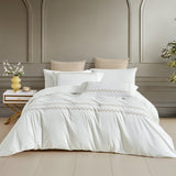 A timeless white bedding set featuring exquisite horizontal gold embroidered borders, perfect for a modern, upscale interior.