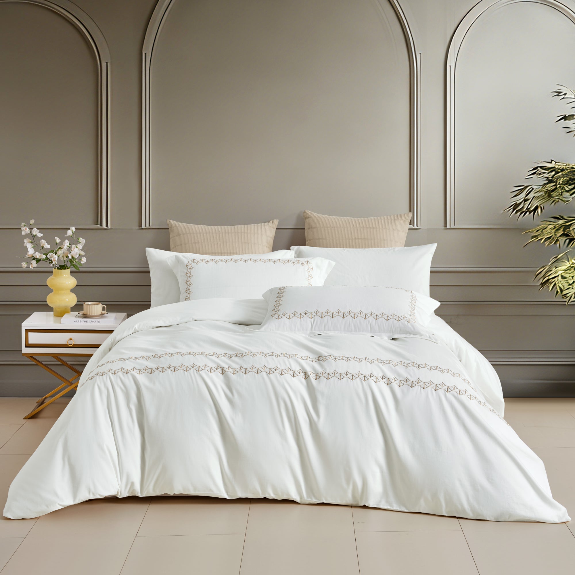 A timeless white bedding set featuring exquisite horizontal gold embroidered borders, perfect for a modern, upscale interior.