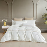 A timeless white bedding set featuring exquisite horizontal gold embroidered borders, perfect for a modern, upscale interior.