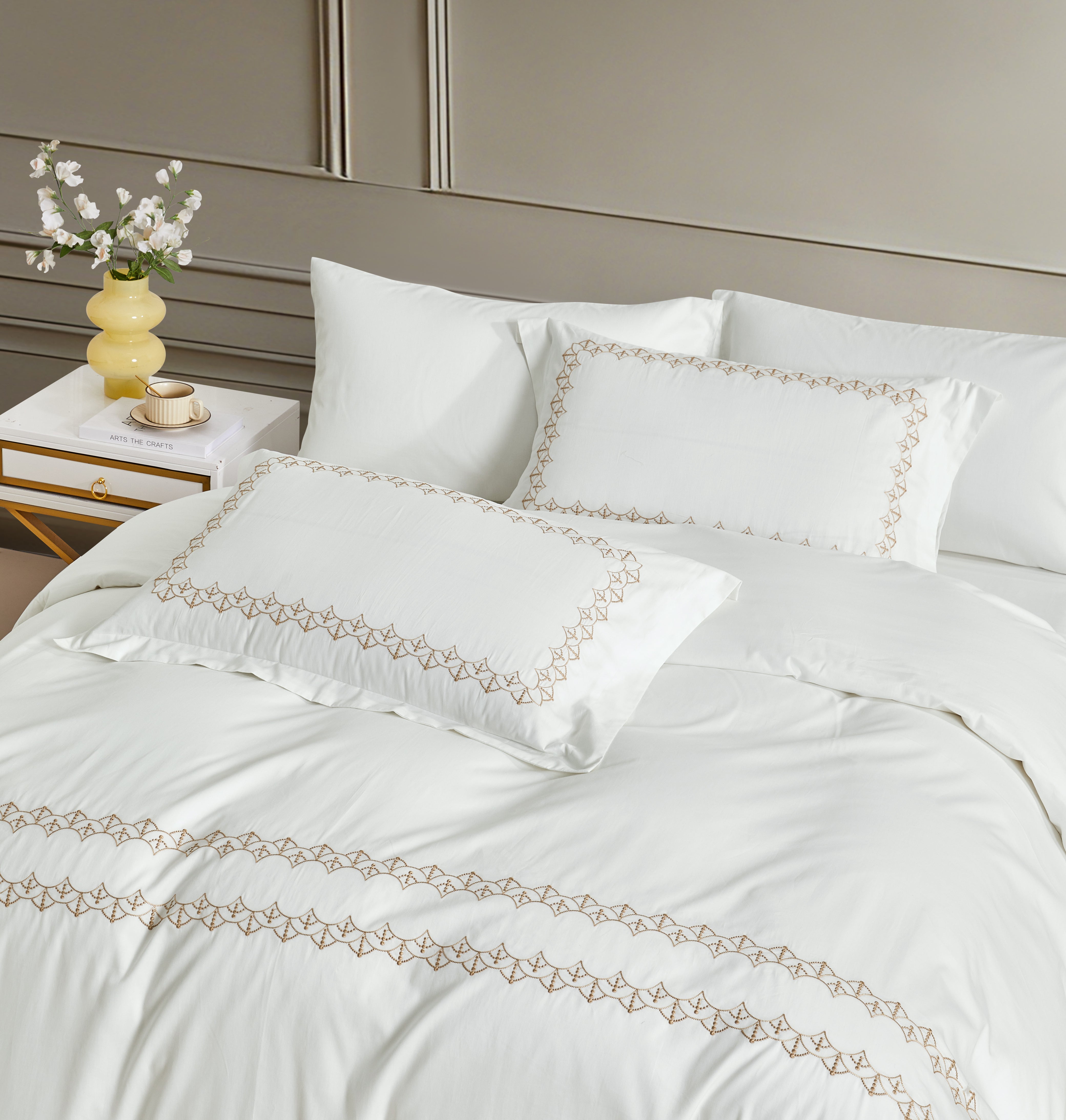 Sophisticated scalloped gold embroidery adds a touch of royal elegance to the crisp white cotton fabric.