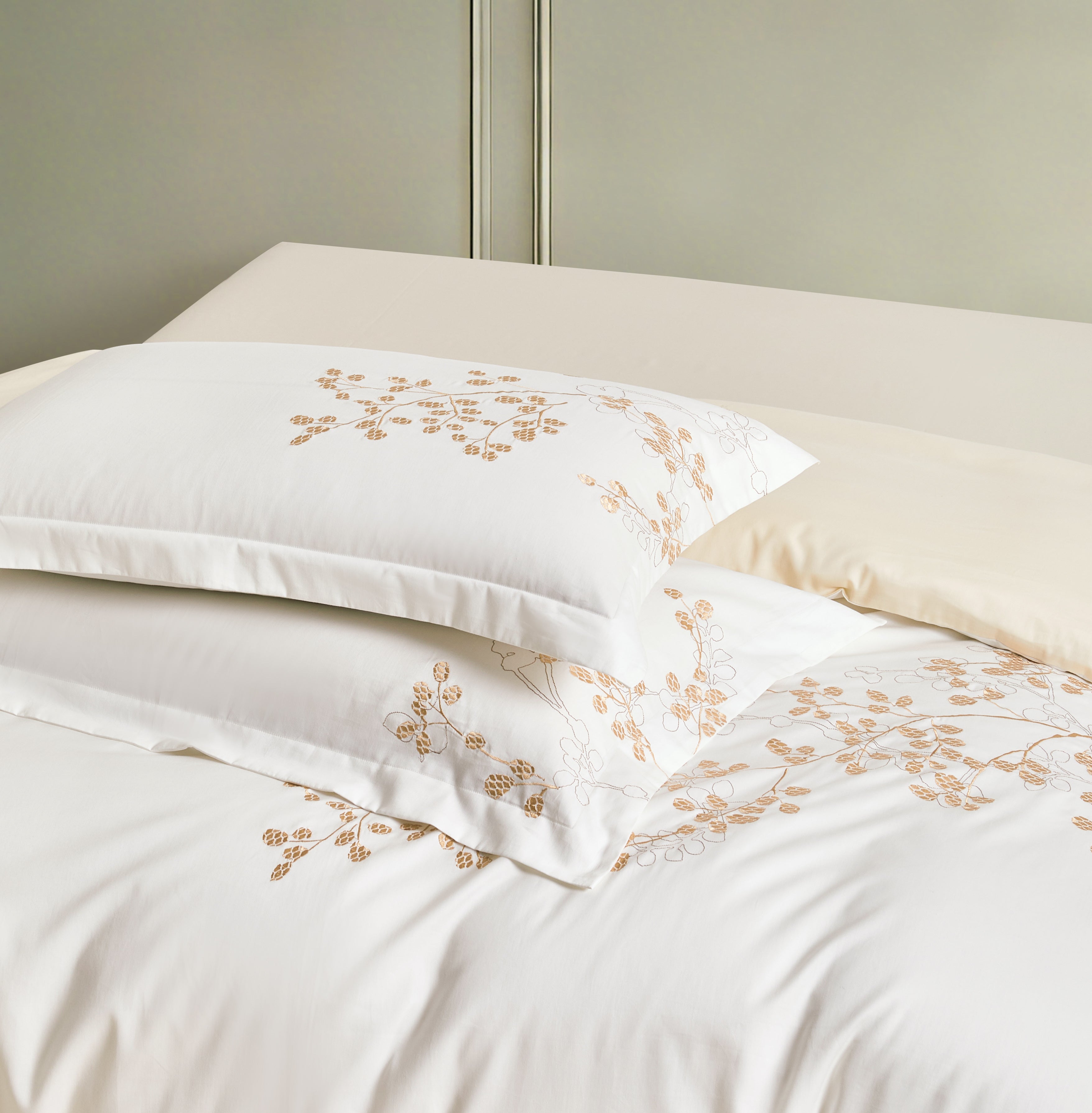 Features exquisite botanical embroidery in a warm copper hue, adding a refined organic touch to the crisp white fabric.