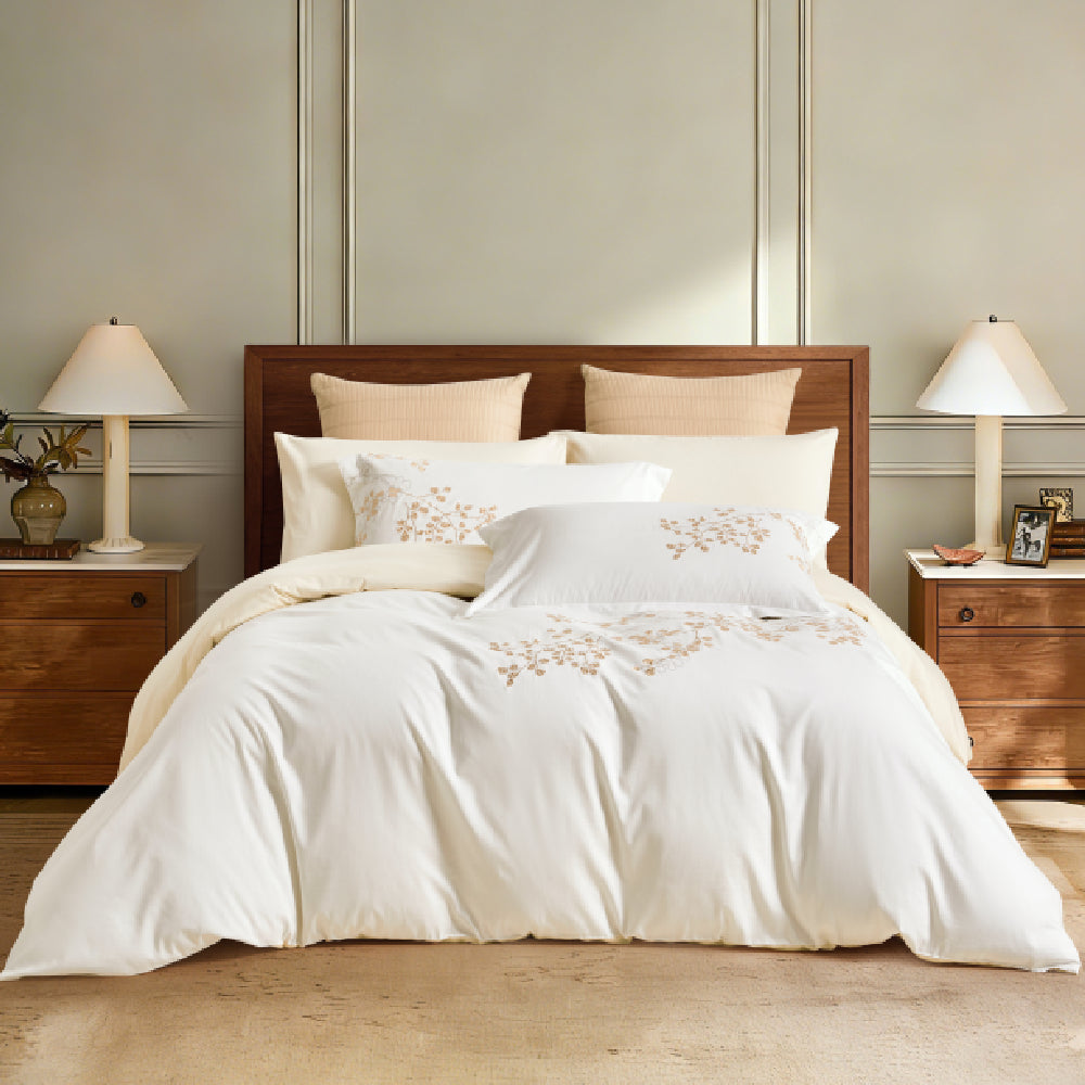 A complete bedding set styled in a sophisticated room with walnut furniture and warm lighting, perfect for a cozy yet elegant master suite.