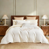 A complete bedding set styled in a sophisticated room with walnut furniture and warm lighting, perfect for a cozy yet elegant master suite.