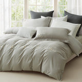 Stacked white pillowcases with vertical pink embroidery and professional flanged edges.