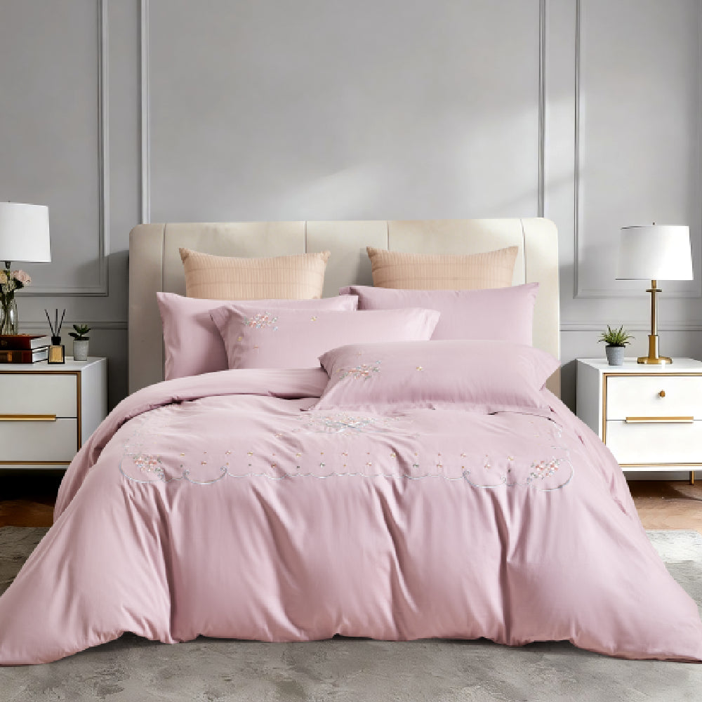 Frontal view of a luxury bed set with sophisticated grey and silver botanical embroidery.