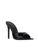 Angled front view of the mule, emphasizing the wide patent strap and the modern, open-toe pointed base.