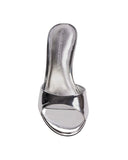 Overhead shot of a metallic silver mule showing the reflective leather footbed, brand logo, and the minimalist open-toe construction.