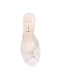 Overhead shot of a Black Suede Studio white mesh mule showing the peep-toe design, large pearl accent, and ivory leather insole with gold branding.